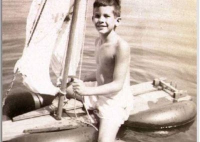black and white picture of young boy sailing in Wellfleet Harbor